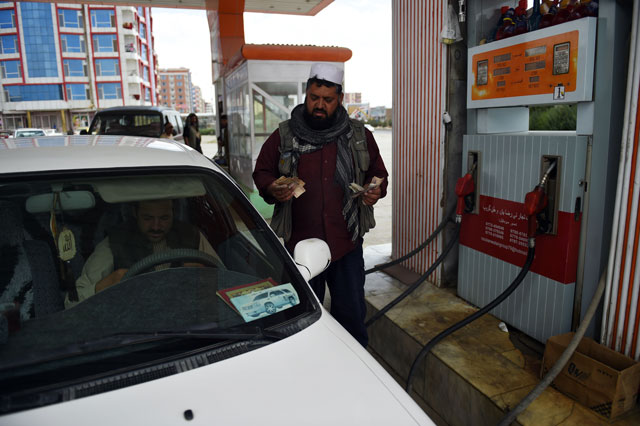 in this photograph taken on august 29 2016 an afghan workers fills a vehicle with fuel at a petrol station on the outskirts of kabul photo afp