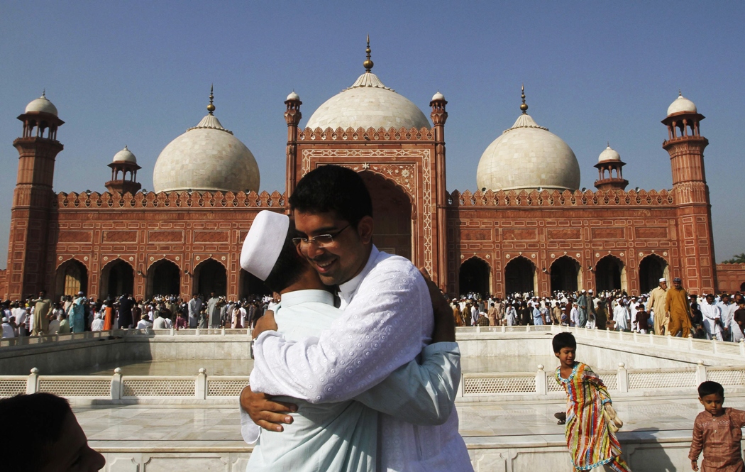 people greet each other after offering eid prayers in lahore october 16 2013 photo reuters