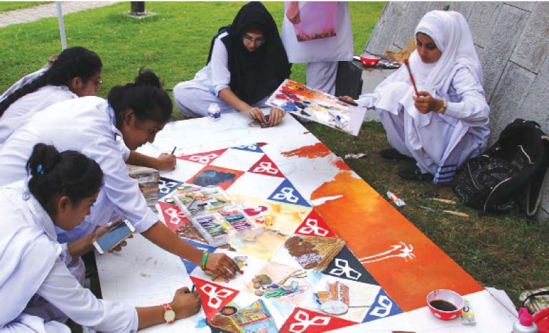 a group of young artists works on his art piece at the competition photo express