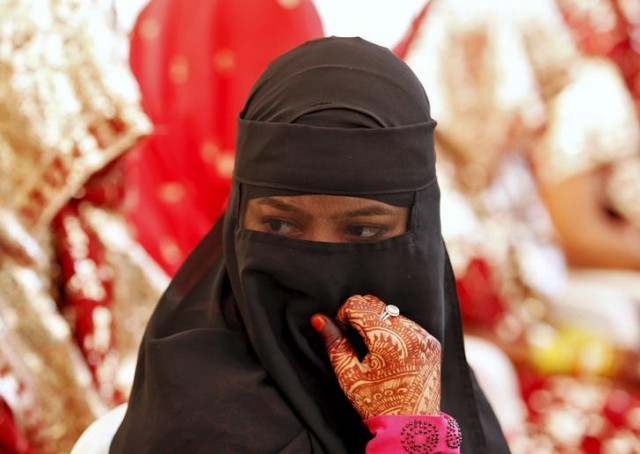 a veiled muslim bride waits for the start of a mass marriage ceremony in ahmedabad india october 11 2015 photo reuters a veiled muslim bride waits for the start of a mass marriage ceremony in ahmedabad india october 11 2015 photo reuters