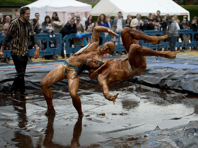 wrestlers wearing fancy dress tackled a slippery surface for a somewhat unusual contest photo afp