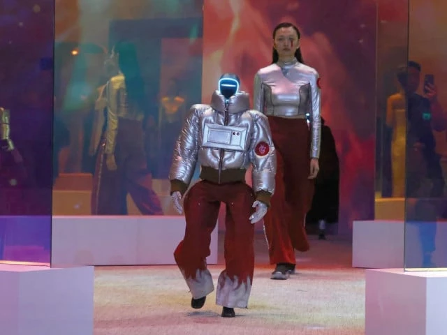 a model and an android walk the runway during a fashion show in seoul photo rte a model and an android walk the runway during a fashion show in seoul photo rte