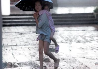 extreme weather a person carries a child while walking with an umbrella as rain intensifies ahead of the arrival of typhoon bavi in wenzhou china photo reuters
