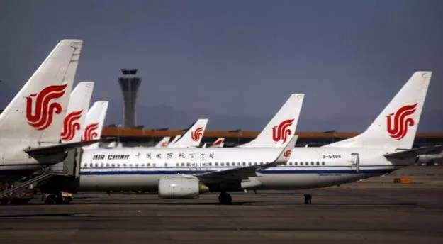 an airport worker inspects the under carriage of air china planes while they are parked at the terminal building of beijing 039 s international airport february 6 2012 photo reuters an airport worker inspects the under carriage of air china planes while they are parked at the terminal building of beijing 039 s international airport february 6 2012 photo reuters
