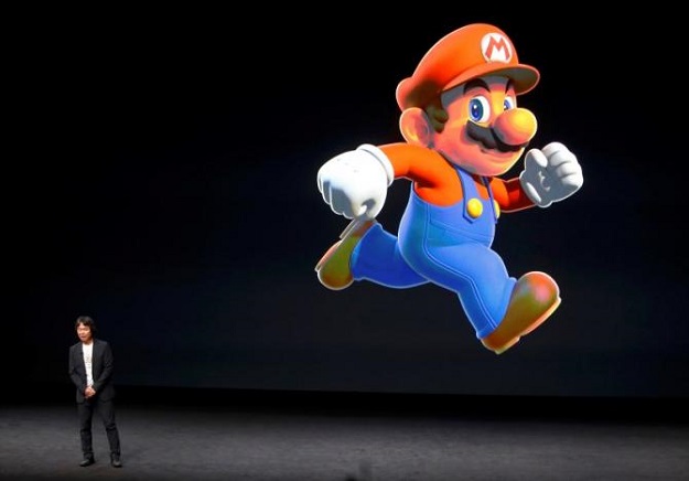 nintendo creative fellow shigeru miyamoto stands next to the super mario character during an apple media event in san francisco photo reuters