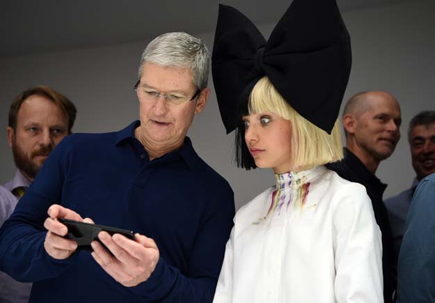 apple ceo tim cook l shows dancer maddie ziegler r a new iphone during a product demonstration at bill graham civic auditorium in san francisco california on september 07 2016 photo afp