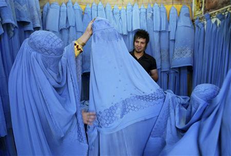 An Afghan woman looks at merchandise at a burqa shop in Herat in western Afghanistan July 2, 2009. PHOTO: REUTERS
