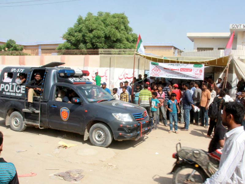 a police mobile van parked by a camp office set up by the mqm for the by election on the malir based ps 127 mqm leader khawaja izharul hassan says their camp was dismantled twice by rival parties photo athar khan express