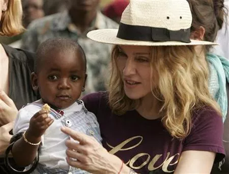 madonna holds her adopted son david banda at an orphan care centre run by raising malawi a grassroots initiative by madonna in mphendula village photo reuters madonna holds her adopted son david banda at an orphan care centre run by raising malawi a grassroots initiative by madonna in mphendula village photo reuters