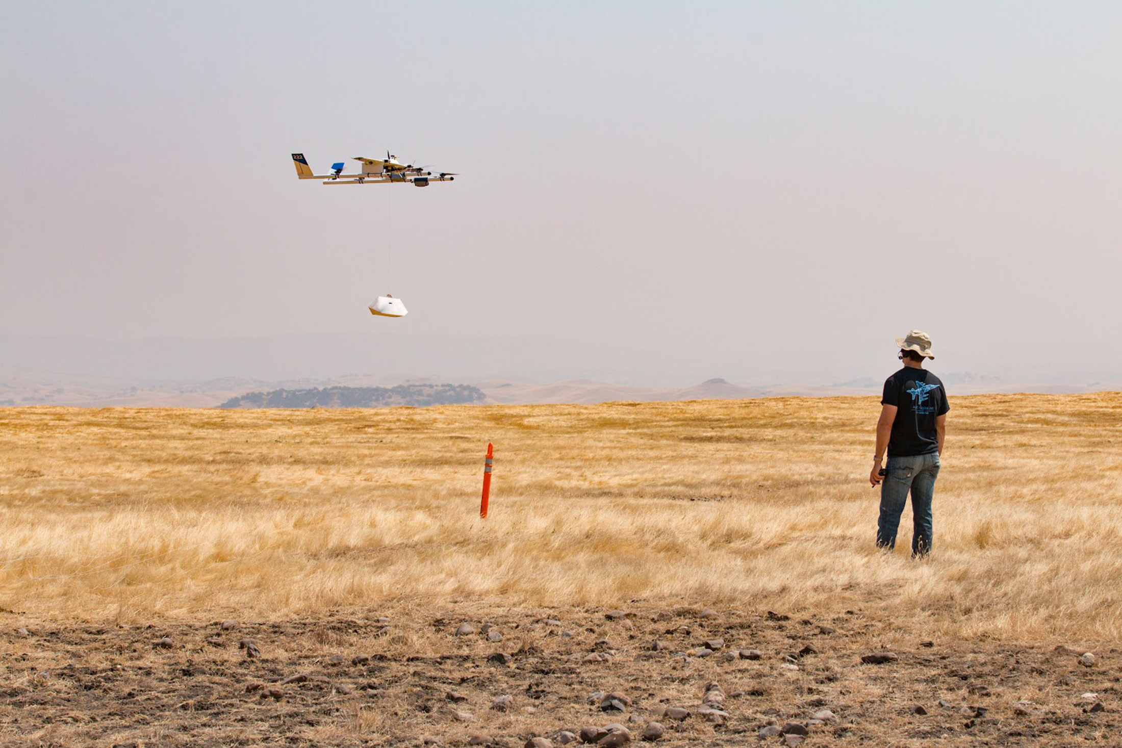 a project wing aircraft lowering a package to the ground during recent testing photo alphabet inc