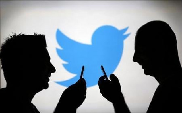 men are silhouetted against a video screen with a twitter logo photo reuters men are silhouetted against a video screen with a twitter logo photo reuters
