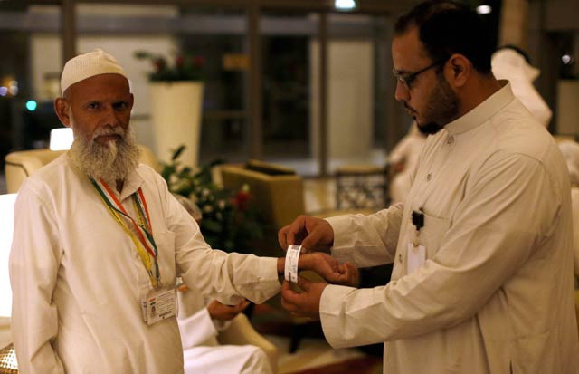 a saudi official adjusts an electronic identification bracelet that saudi authorities are giving to pilgrims ahead of the annual hajj muslim pilgrimage photo afp a saudi official adjusts an electronic identification bracelet that saudi authorities are giving to pilgrims ahead of the annual hajj muslim pilgrimage photo afp