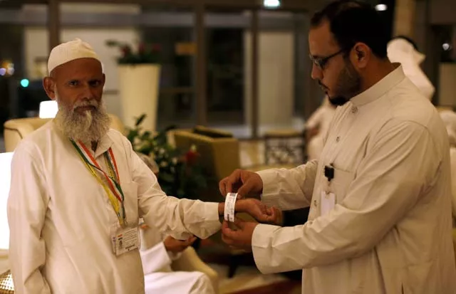 a saudi official adjusts an electronic identification bracelet that saudi authorities are giving to pilgrims ahead of the annual hajj muslim pilgrimage photo afp a saudi official adjusts an electronic identification bracelet that saudi authorities are giving to pilgrims ahead of the annual hajj muslim pilgrimage photo afp