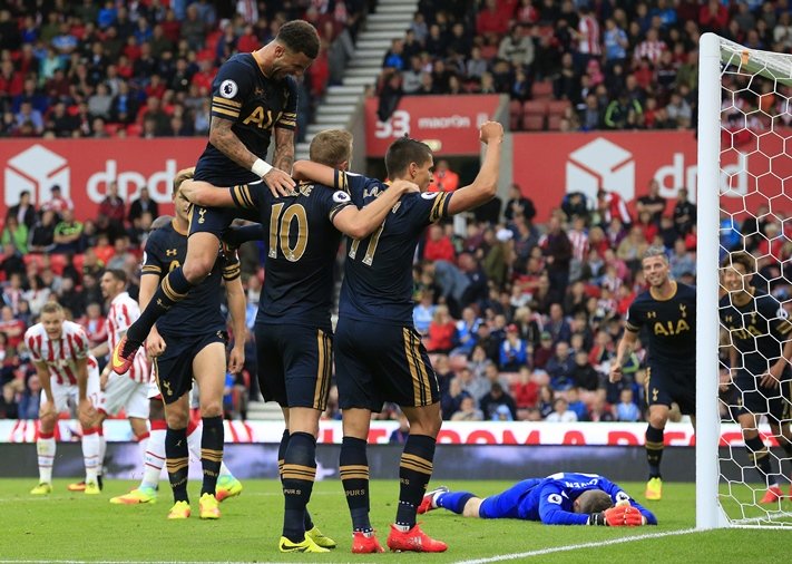 tottenham hotspur 039 s english striker harry kane c is mobbed by teammates after scoring his team 039 s fourth goal during the english premier league football match between stoke city and tottenham hotspur at the bet365 stadium in stoke on trent central england on september 10 2016 photo afp