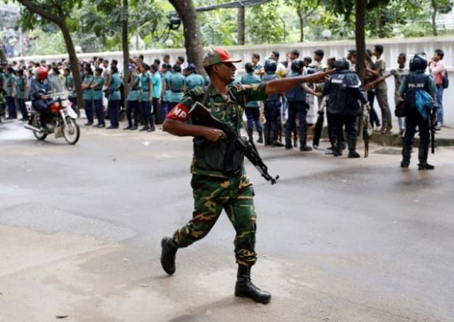 a security personnel reacts near the holey artisan restaurant after gunmen attacked the upscale cafe in dhaka bangladesh photo reuters a security personnel reacts near the holey artisan restaurant after gunmen attacked the upscale cafe in dhaka bangladesh photo reuters