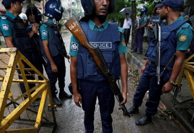 policemen stand guard along a road leading to the holey artisan bakery and the o 039 kitchen restaurant after gunmen attacked in dhaka bangladesh july 3 2016 photo reuters