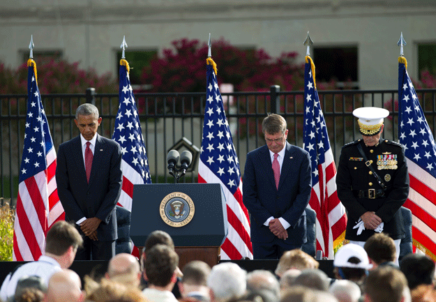 us president barack obama accompanied by defense secretary ash carter c and chairman of the joint chiefs of staff gen joseph dunford r observe moment of silence during a ceremony in observance to mark the15th anniversary of the 9 11 terrorist attacks at the pentagon memorial in washington dc september 11 2016 photo afp