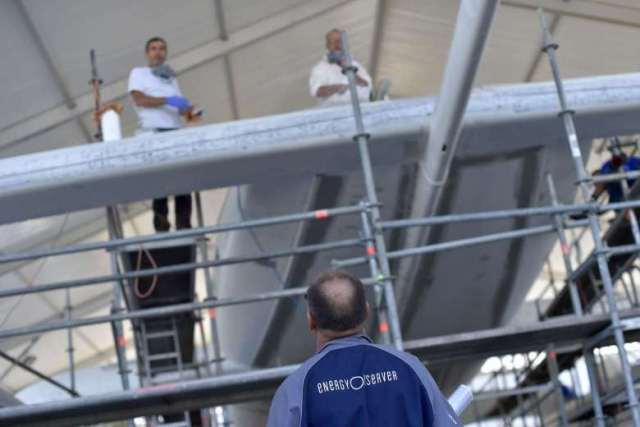 men work on the hull of an under construction self energy producer multihull quot energy observer quot on sept 6 in saint malo western france photo afp