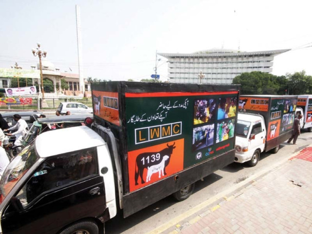 lahore waste management company trucks parked on a roadside at faisal chowk photos naveen bokhari express lahore waste management company trucks parked on a roadside at faisal chowk photos naveen bokhari express