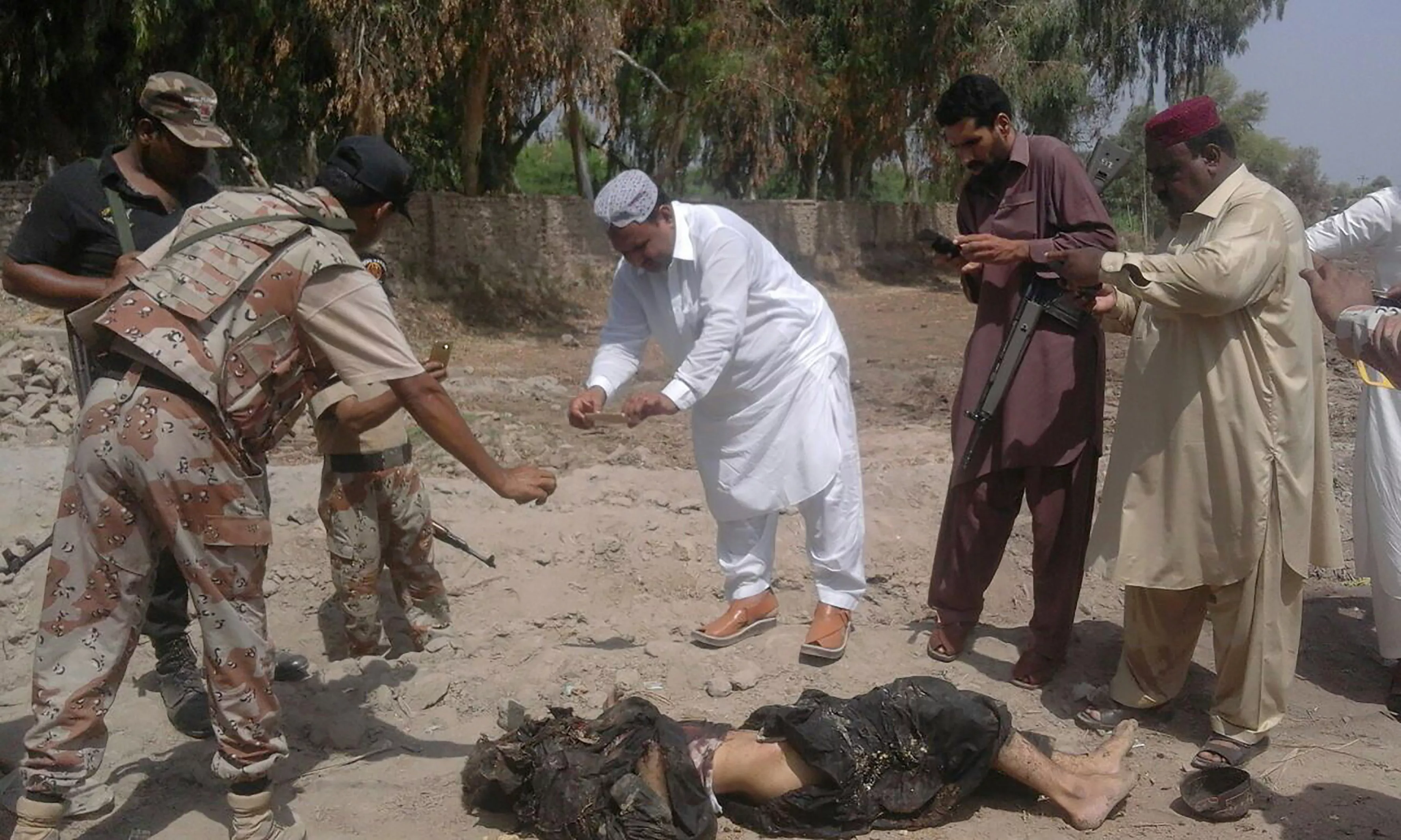 security officials gather around the site of a shia mosque in shikarpur on tuesday photo afp security officials gather around the site of a shia mosque in shikarpur on tuesday photo afp
