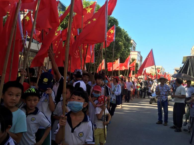 villagers including schoolchildren take part in a protest against the arrest of village chief lin zuluan in wukan in china 039 s guangdong province june 22 2016 reuters james pomfret