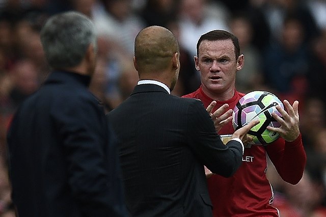manchester united 039 s english striker wayne rooney r and manchester city 039 s spanish manager pep guardiola clash on the touchline as rooney tries to retrieve the ball during the english premier league football match between manchester united and manchester city at old trafford in manchester north west england on september 10 2016 photo afp