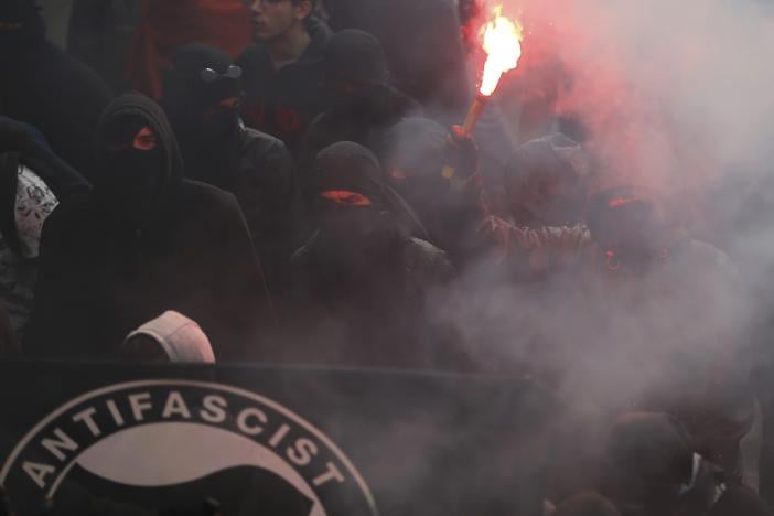 masked protesters light a flare as they take part in a march in nantes western france to demonstrate against the new french labour law september 15 2016 photo reuters