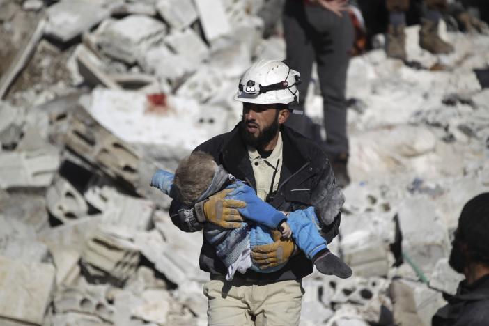 a civil defence member carries a dead child in a site hit by what activists said were airstrikes carried out by the russian air force in the rebel controlled area of maaret al numan town in idlib province syria photo reuters