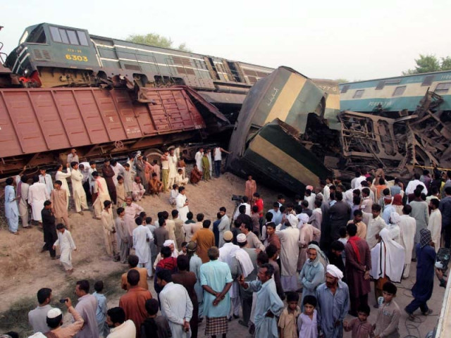 people gather near the wreckage of the two trains on the outskirts of multan photo afp people gather near the wreckage of the two trains on the outskirts of multan photo afp
