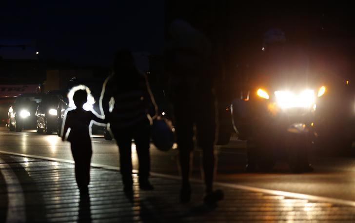 migrants walk in the night along the highway towards the border with austria some 22 km of budapest hungary september 4 2015 photo reuters