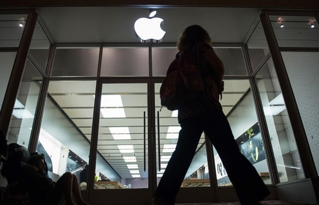 a woman walks past batu adamis from turkey sleeping outside the apple store to buy the new apple iphone 7 photo afp a woman walks past batu adamis from turkey sleeping outside the apple store to buy the new apple iphone 7 photo afp