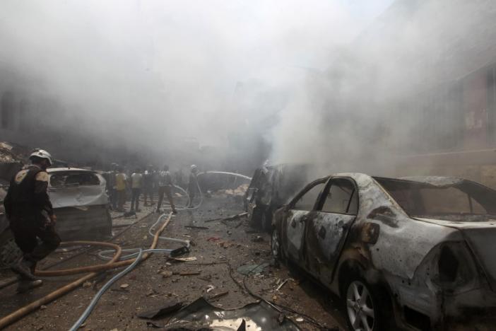 smoke rises over a damaged site as civil defence members try to put out a fire after an airstrike on al jalaa street in the rebel held city of idlib syria photo reuters