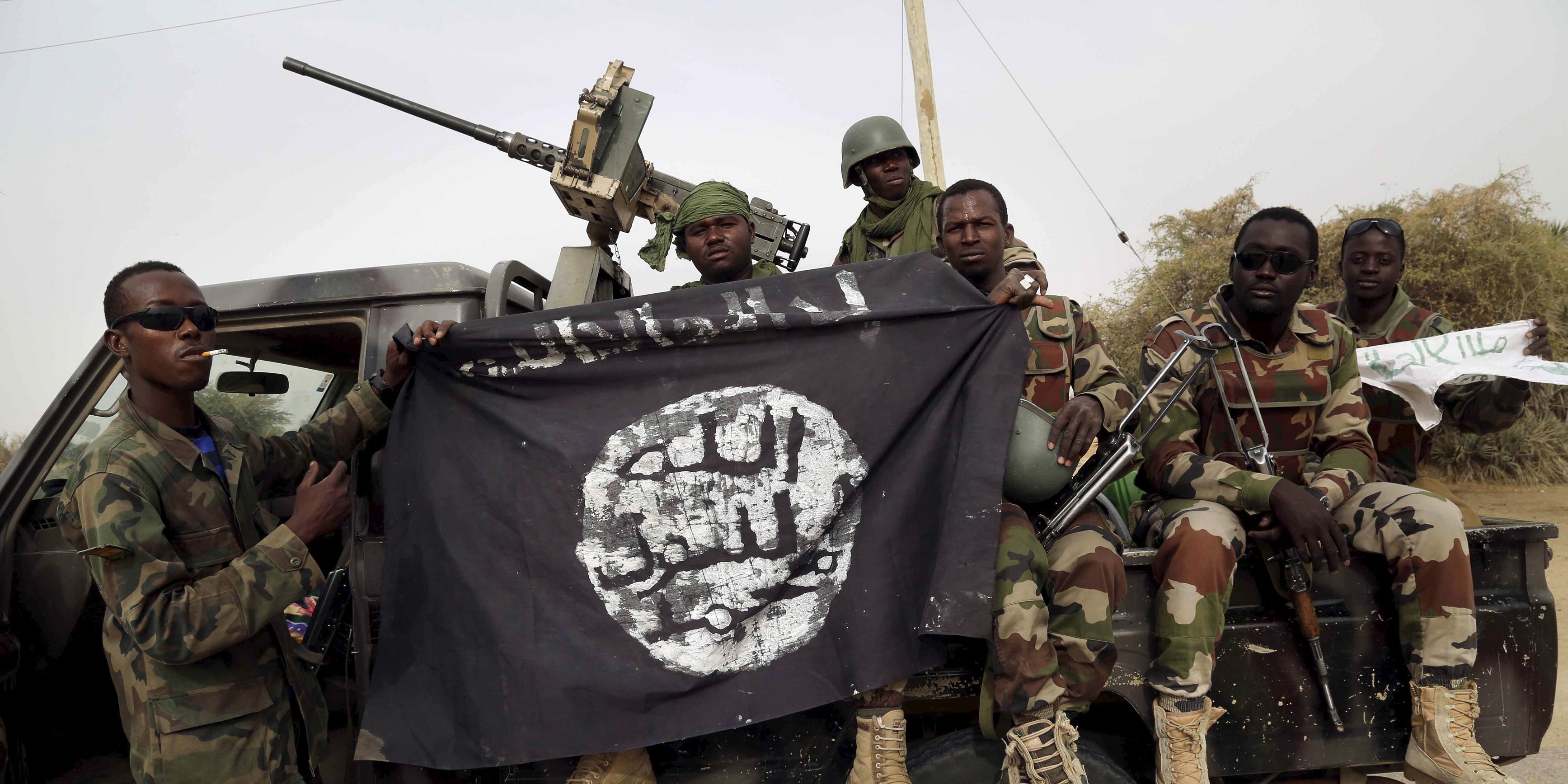 nigerian soldiers hold up a boko haram flag that they had seized in the recently retaken town of damasak photo reuters