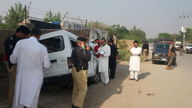 investigators collect evidence from the sight of a targetted attack on security personnel in gari sohbat khan area of peshawar on sunday photo express