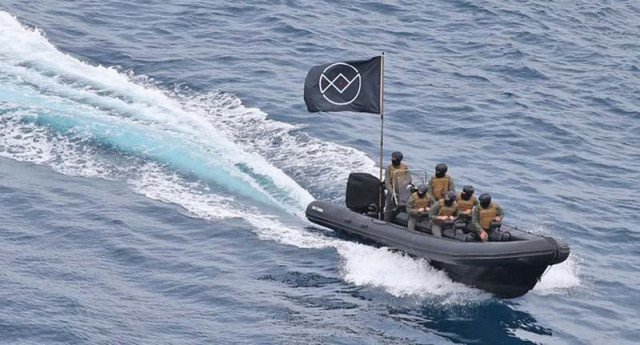 six men swept up to eden roc hotel in a high powered dinghy that displayed a black flag photo file six men swept up to eden roc hotel in a high powered dinghy that displayed a black flag photo file