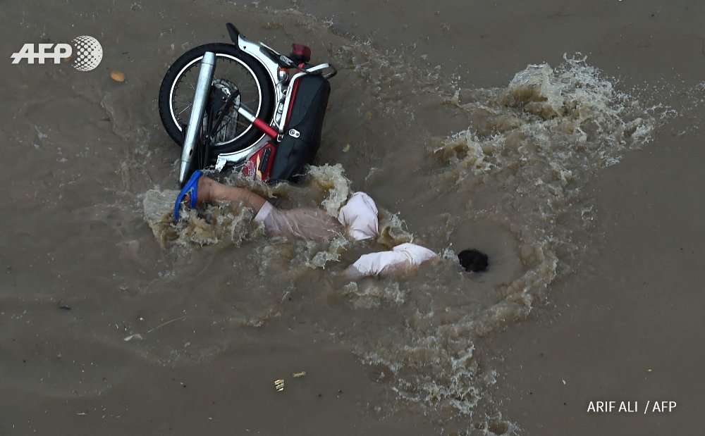 picture shows a biker has fallen down after heavy rainfall was witnessed by lahore on august 25 2016 photo afp