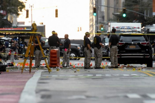 evidence markers on the street surround federal bureau of investigation fbi officials near the site of an explosion in the chelsea neighborhood of manhattan new york us september 18 2016 photo reuters evidence markers on the street surround federal bureau of investigation fbi officials near the site of an explosion in the chelsea neighborhood of manhattan new york us september 18 2016 photo reuters