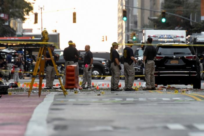 evidence markers on the street surround federal bureau of investigation fbi officials near the site of an explosion in the chelsea neighborhood of manhattan new york us september 18 2016 photo reuters