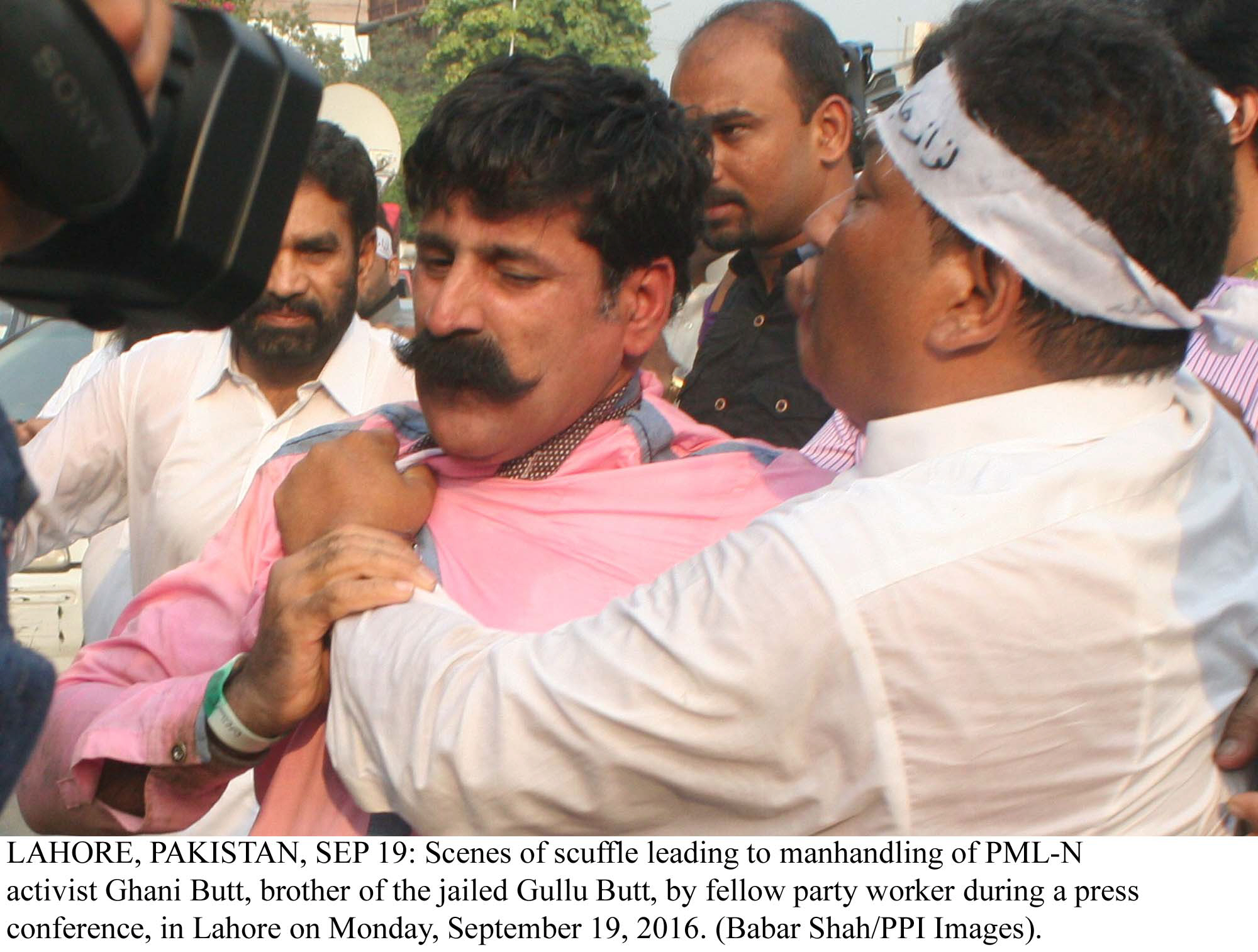 scenes of scuffle leading to manhandling of pml n activist ghani butt brother of the jailed gullu butt photo ppi