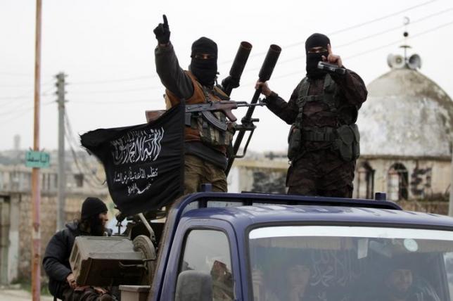 members of al qaeda 039 s nusra front gesture as they drive in a convoy touring villages photo reuters
