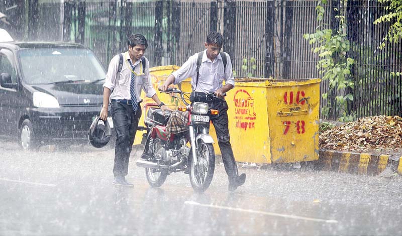 two boys push a motorcycle to their destination during rain in the city photo app