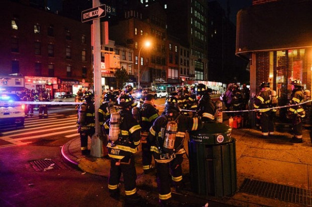 new york city firefighters stand near the site of the blast photo afp new york city firefighters stand near the site of the blast photo afp