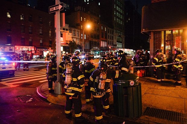 new york city firefighters stand near the site of the blast photo afp