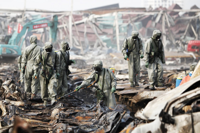 rescuers spray hydrogen peroxide at the site of tianjin warehouse explosion on august 20 2015 in tianjin china photo afp rescuers spray hydrogen peroxide at the site of tianjin warehouse explosion on august 20 2015 in tianjin china photo afp