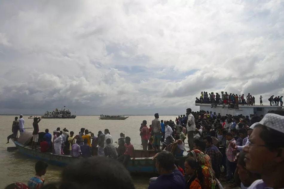 bangladeshi onlookers gather near the scene where an overloaded ferry capsized in the padma river in munshiganj some 30 kilometres 20 miles south of the capital dhaka on august 4 2014 photo afp bangladeshi onlookers gather near the scene where an overloaded ferry capsized in the padma river in munshiganj some 30 kilometres 20 miles south of the capital dhaka on august 4 2014 photo afp
