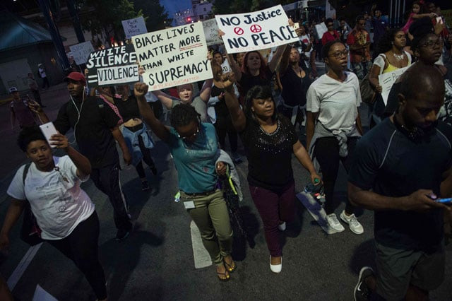 protesters march during a demonstration against police brutality in charlotte north carolina on september 21 2016 photo afp