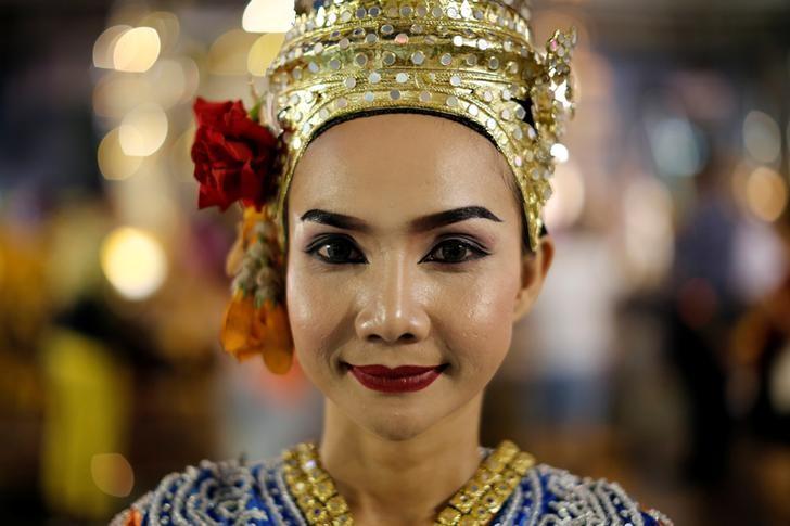 a thai classical dancer poses for photos at the erawan shrine in central of bangkok thailand photo reuters