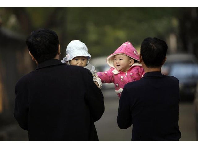 a 10 month old girl touches a boy as her grandfather carries her as they walk along a traditional alleyway or hutong in central beijing november 6 2012 photo reuters a 10 month old girl touches a boy as her grandfather carries her as they walk along a traditional alleyway or hutong in central beijing november 6 2012 photo reuters