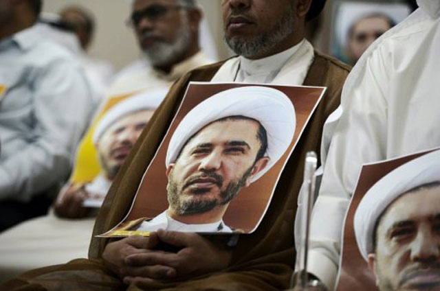 a bahraini holds a portrait of sheikh ali salman head of the shia opposition movement al wefaq during a protest on the outskirts of the capital manama on may 29 2016 photo afp