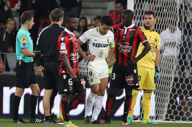 radamel falcao c reacts after a crash with yoan cardinale r on september 21 2016 at allianz riviera stadium in nice france photo afp radamel falcao c reacts after a crash with yoan cardinale r on september 21 2016 at allianz riviera stadium in nice france photo afp